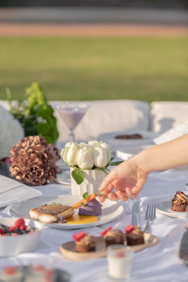 The View Bouznika Hotel Exterior photo A hand reaches for a carrot at a wedding reception